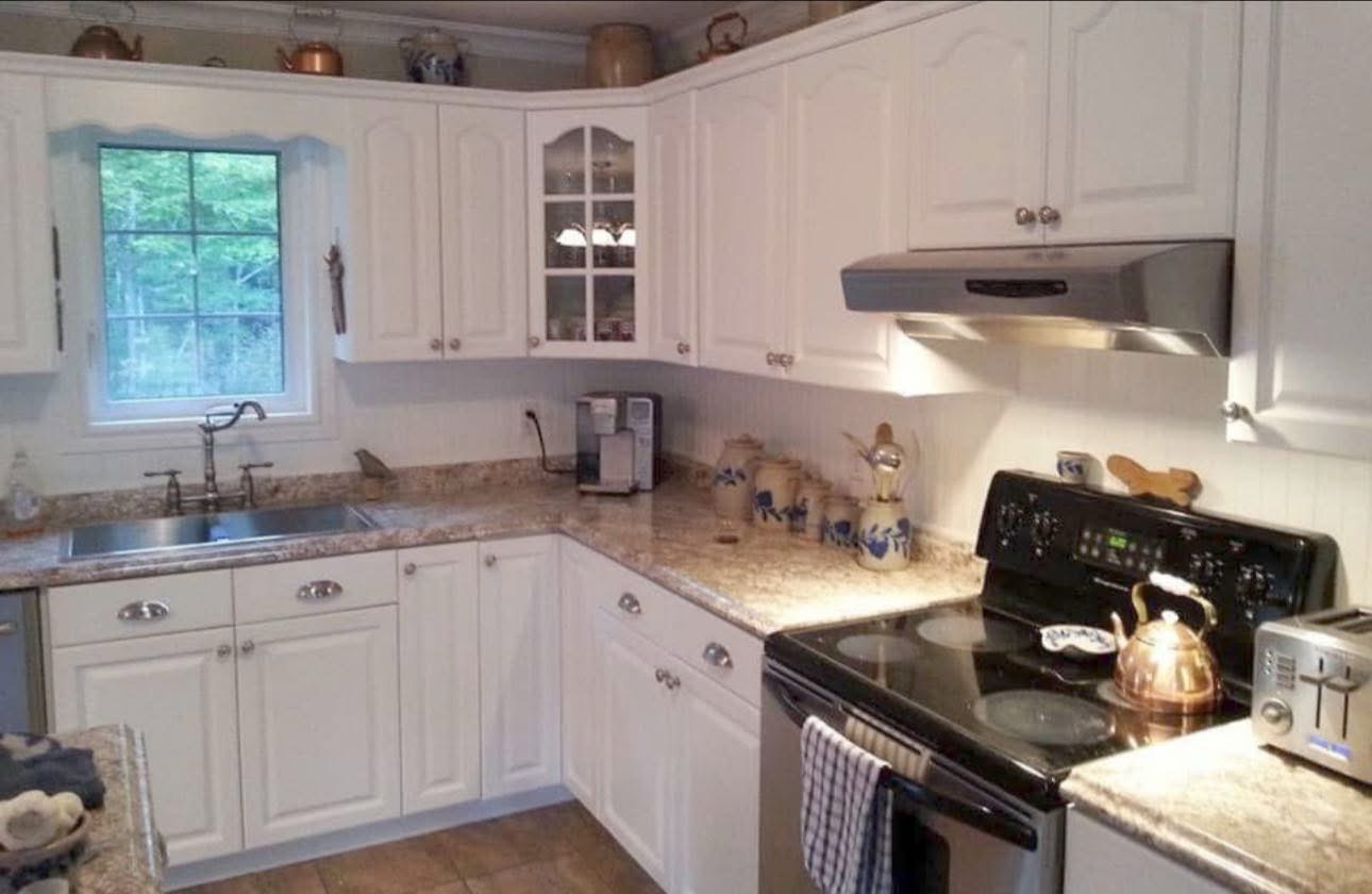 White painted kitchen cabinets with granite counters