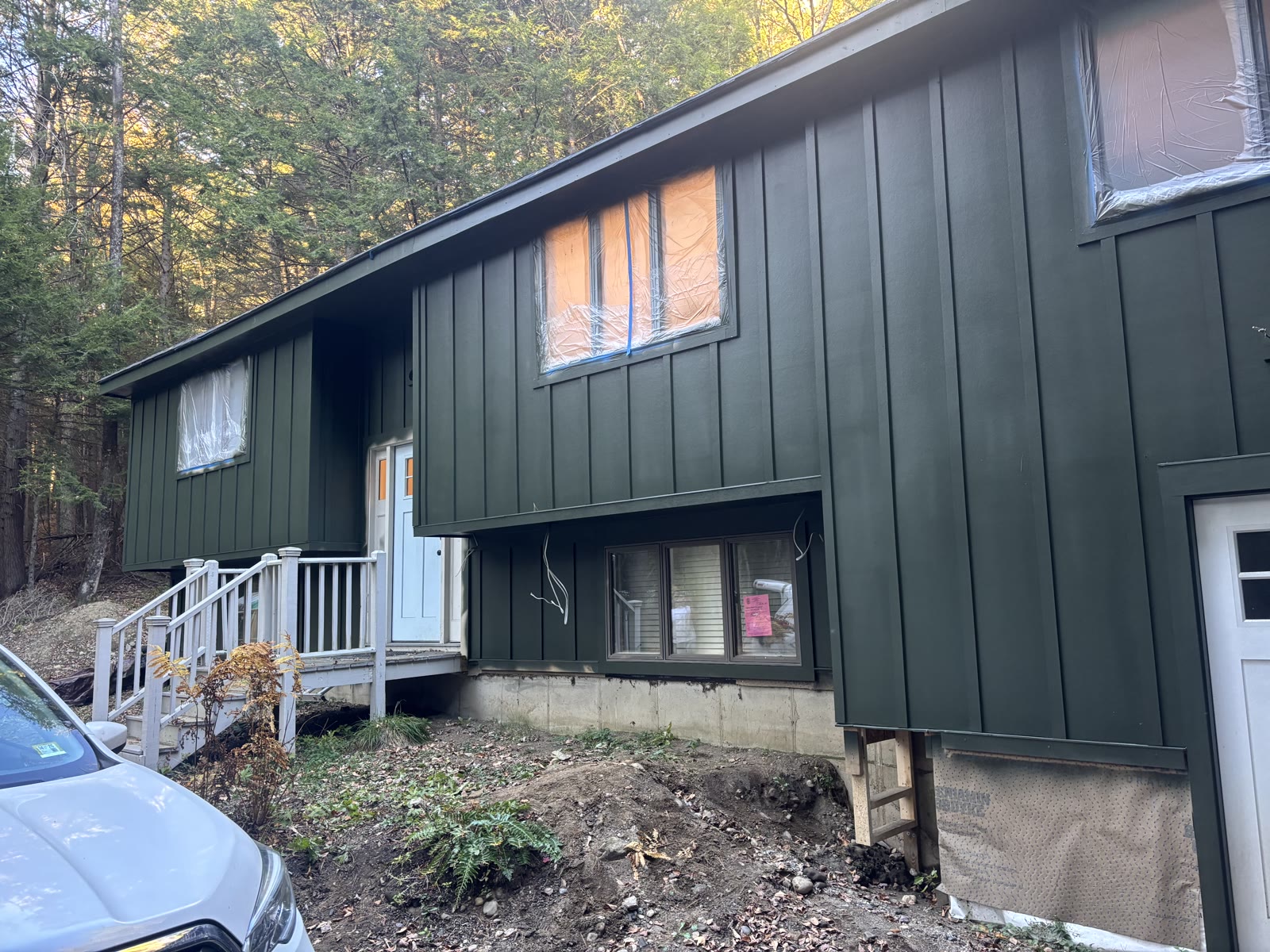 Finished dark forest-green board-and-batten exterior