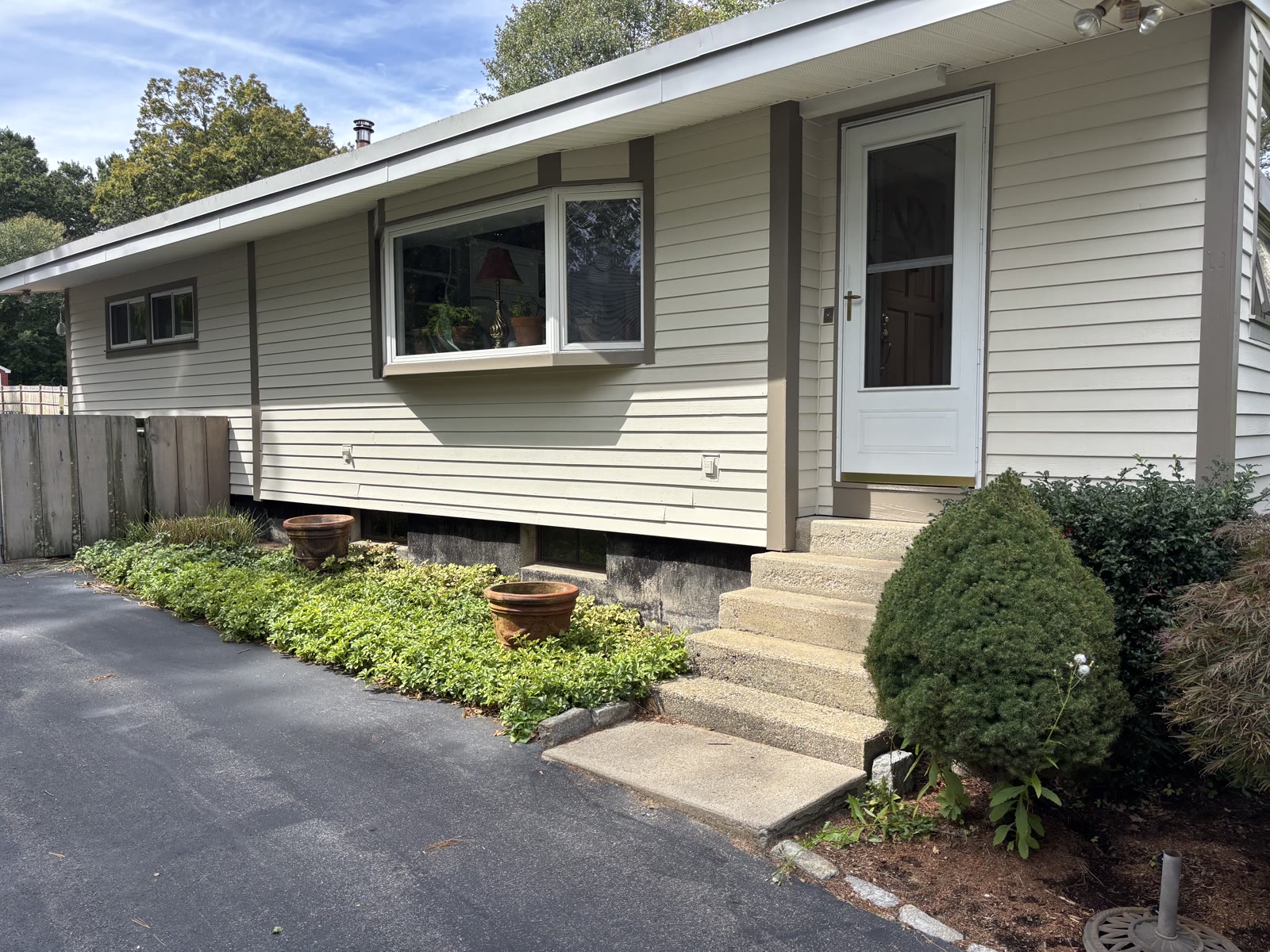 Finished ranch home front entry with white door