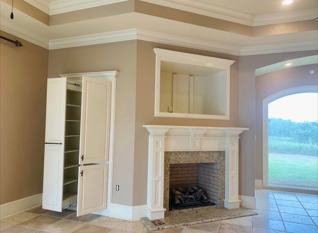 Finished fireplace wall, trim, and built-ins