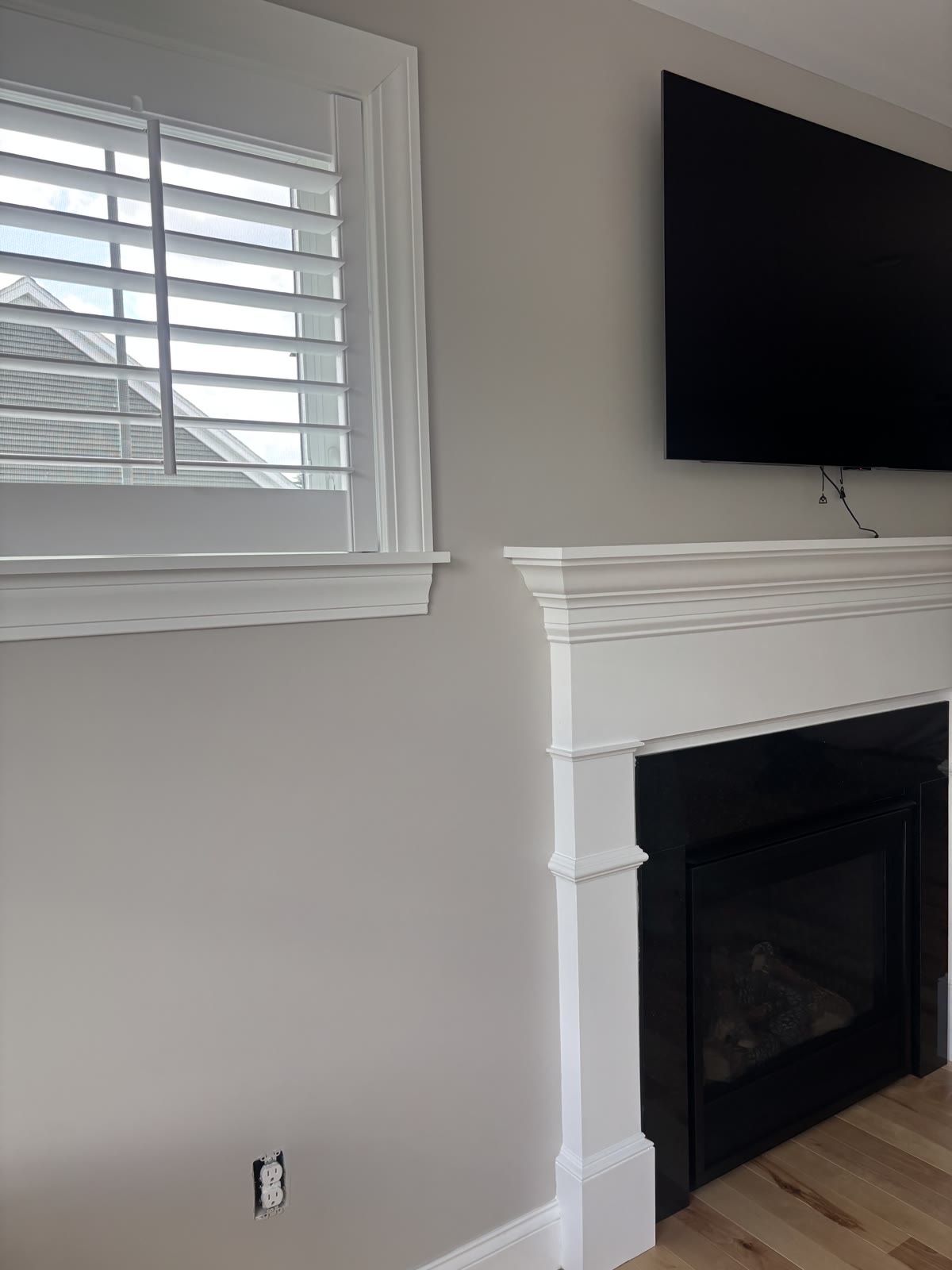 Finished fireplace and mantel with mounted TV